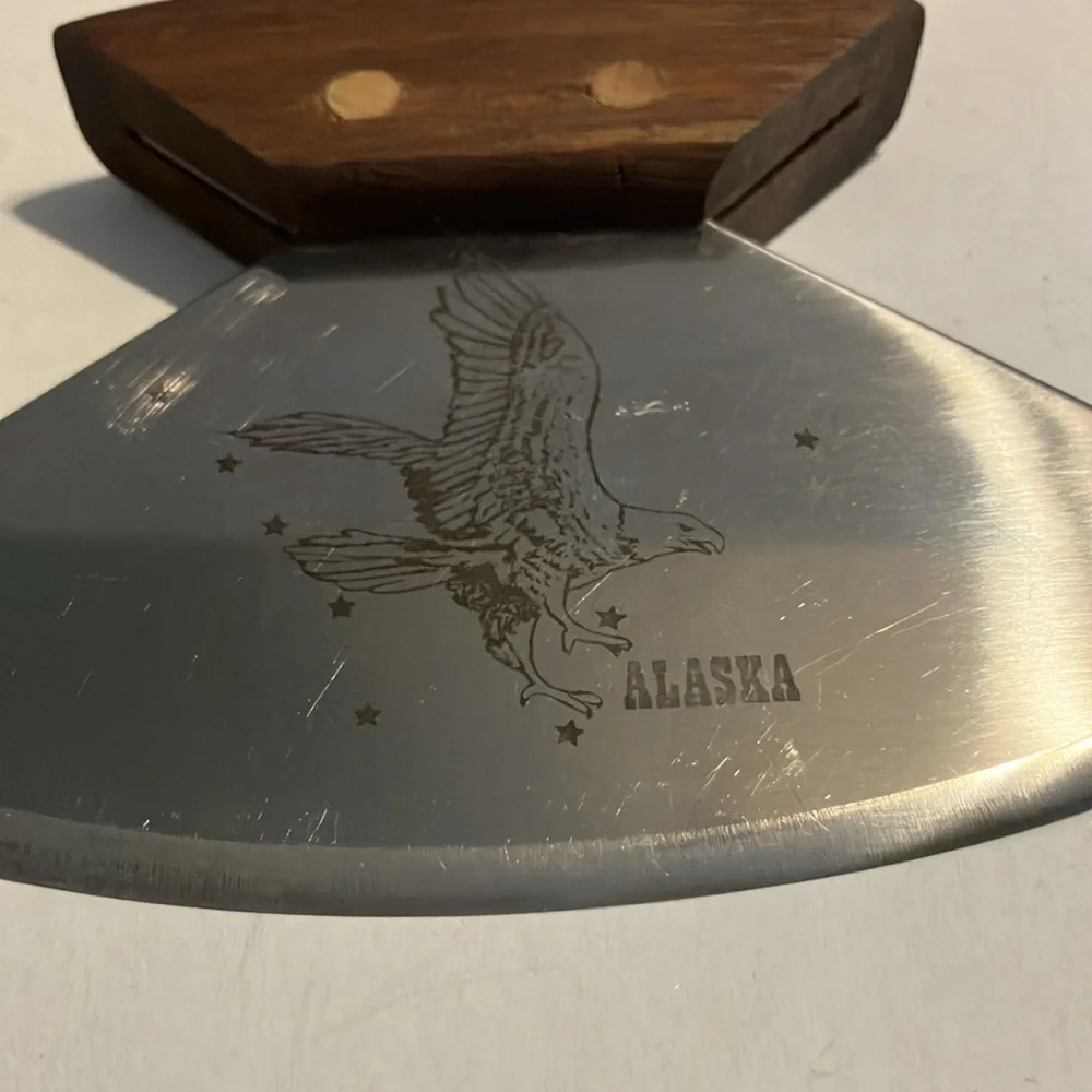 Alaskan Ulu knife with a walnut wood handle and a stand.‎